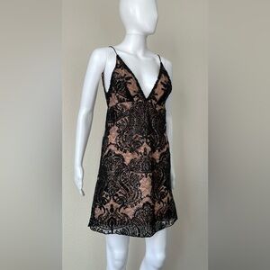 Free people 
Black lace overlay with sequin embellishment mini cocktail dress